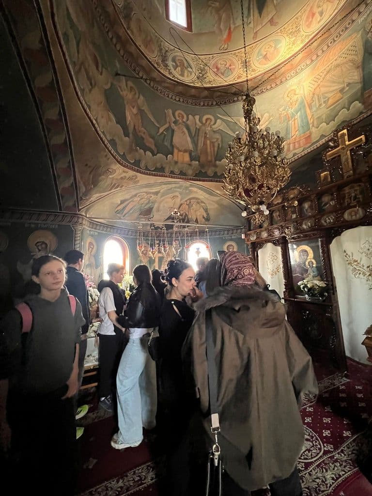 Elevii privind frescele bolții, în timpul vizitei la biserică